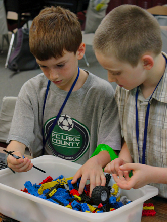 Students building a robot together
